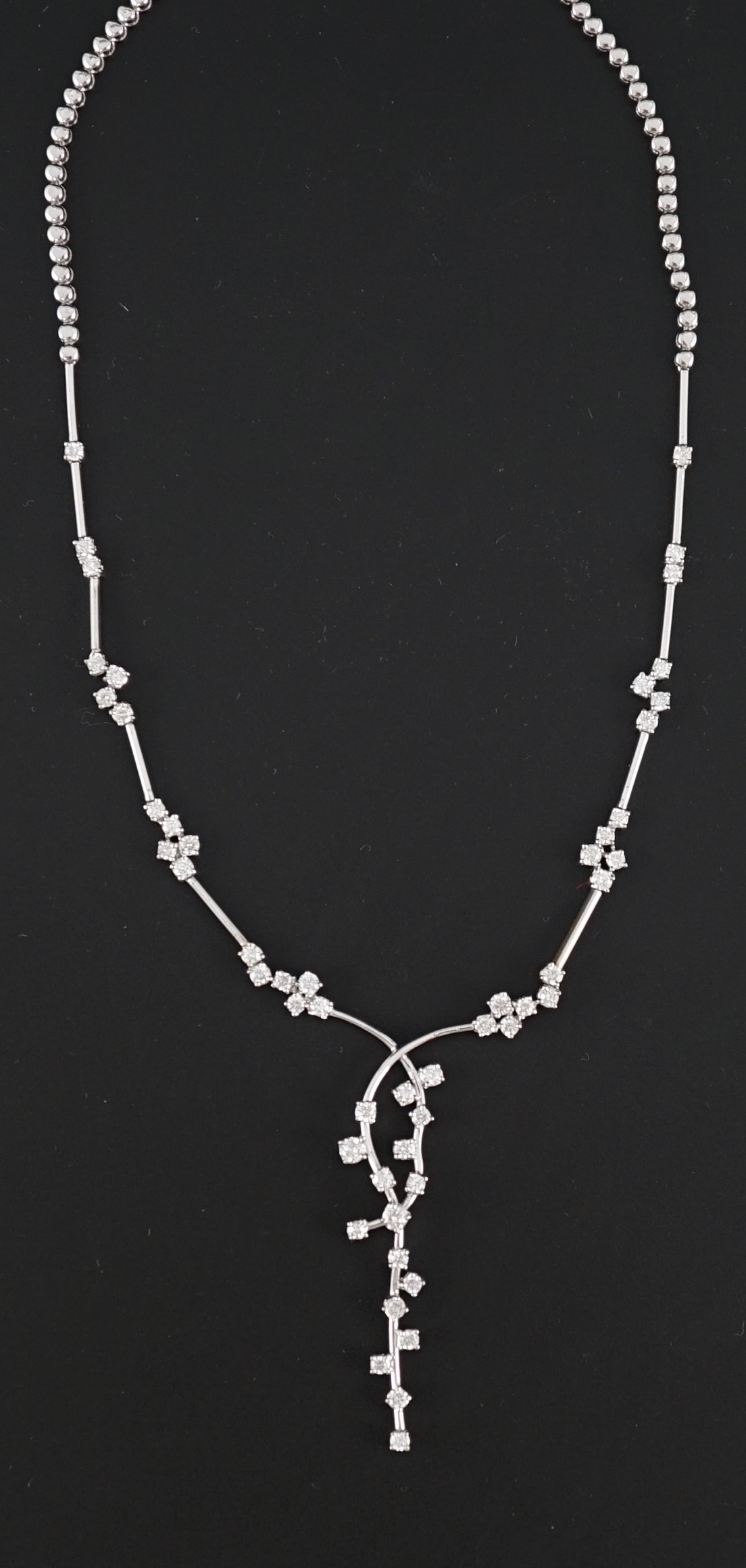 A modern 18k white gold and diamond cluster set necklace